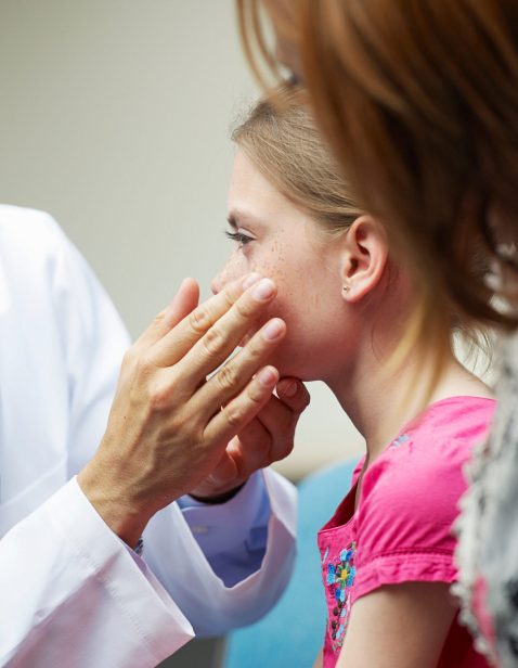 Doctor examining young girl
